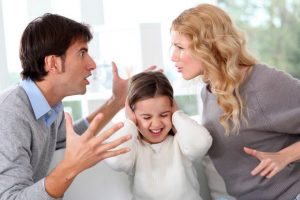 Couple fighting in front of child
